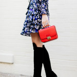 Amy Havins wears a blue floral print Shoshanna dress with Stuart Weitzman over the knee boots.