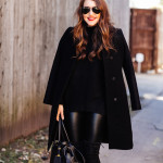 Amy Havins wears an all black look paired with faux leather leggings.