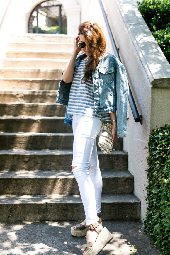 Amy Havins wears white jeans paired with a jean jacket.