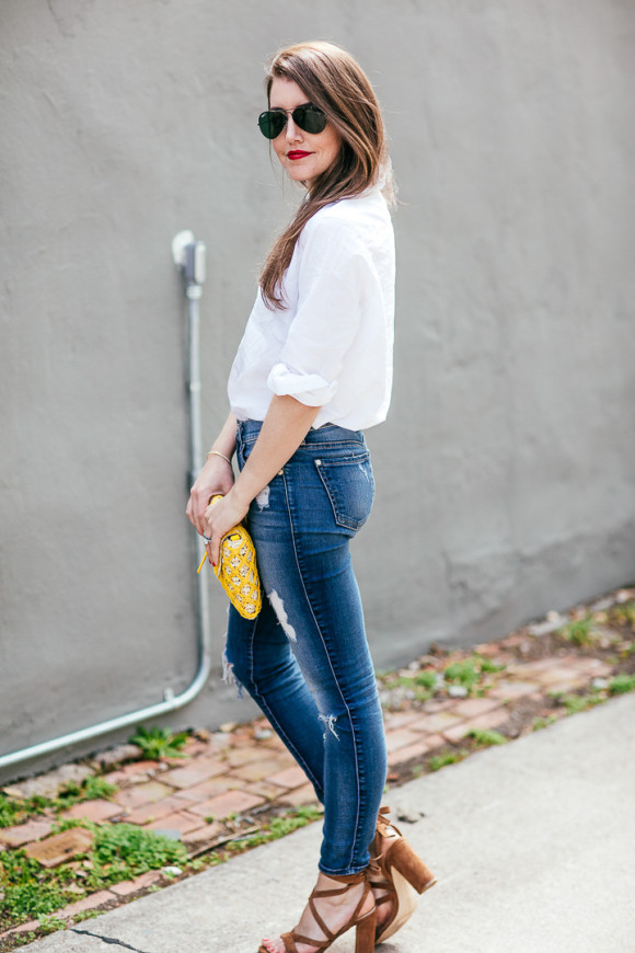 Amy Havins wears ripped 7 for all mankind jeans and a white blouse ...