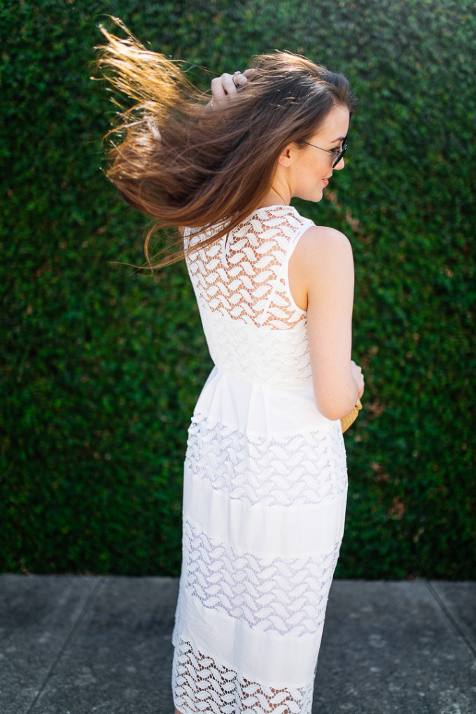 Dallas blogger, Amy Havins, wears a white shoshanna midi dress.