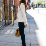 Amy Havins wears a pink peplum blouse with dark skinny jeans.