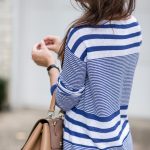 Amy Havins wears a blue and white sweater with white shorts.