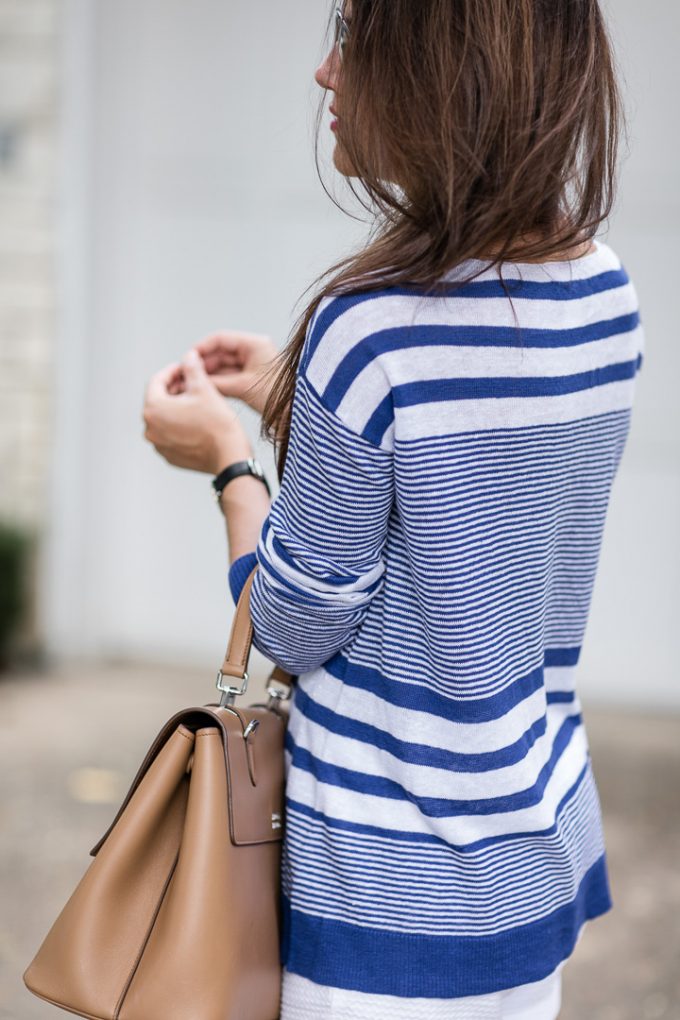 Amy Havins wears a blue and white sweater with white shorts.