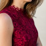 Amy Havins wears a red lace midi Shoshanna dress.