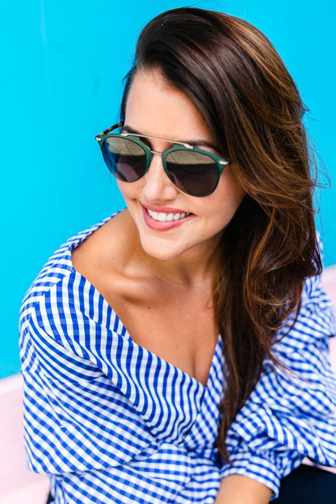 Amy Havins wears a blue and white gingham top with denim.