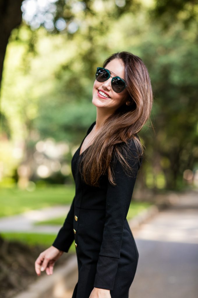 Amy Havins wears a long sleeve black Shoshanna dress and Stuart Weitzman boots.