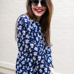 Amy havins wears a navy and white floral print shoshanna long sleeve dress with over the knee boots.