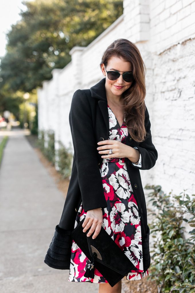 Amy Havins wears a flower dress and a black coat.