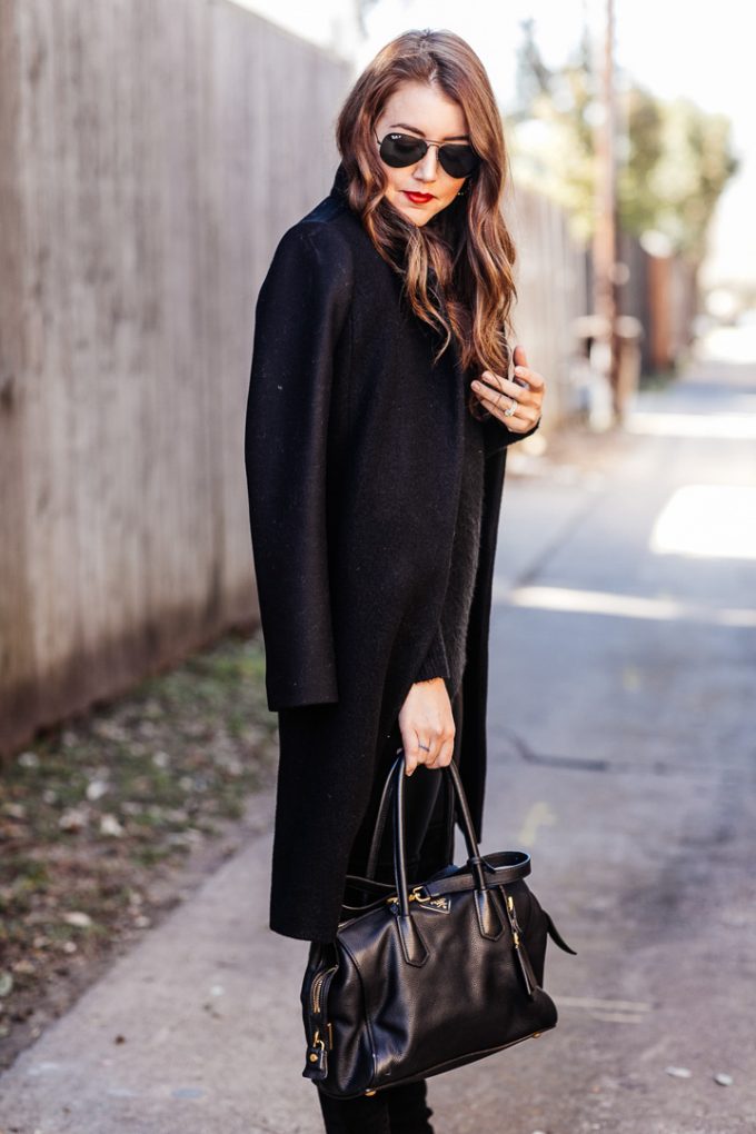 Amy Havins wears black leggings and a black coat.