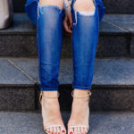 Amy Havins wears ripped jeans and stuart weitzman heels