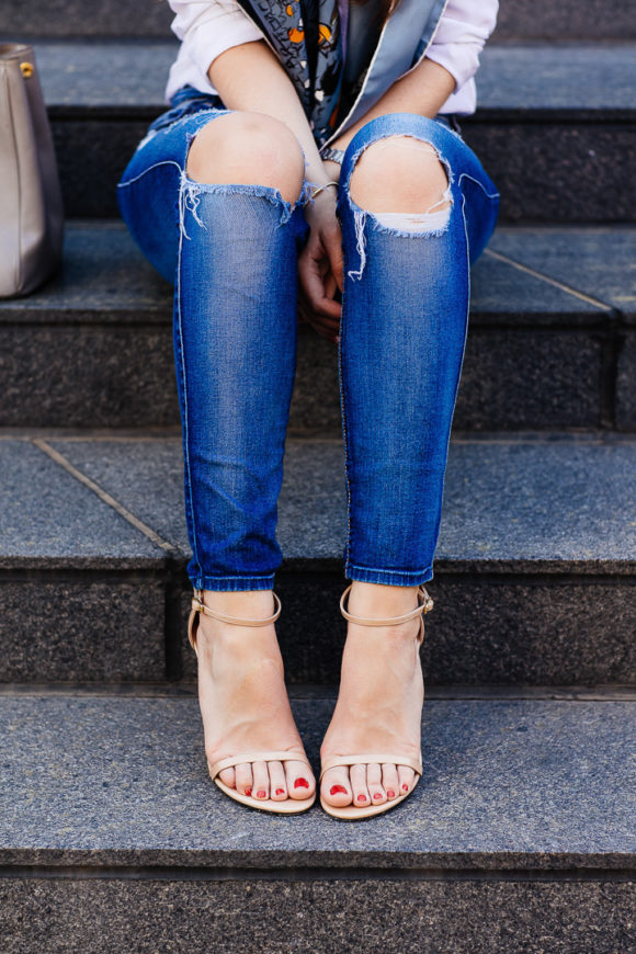 Amy Havins wears ripped jeans and stuart weitzman heels