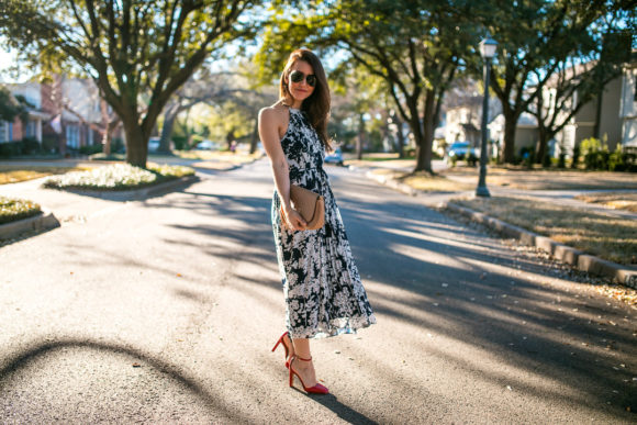 Amy Havins wears a printed midi dress and red heels. 