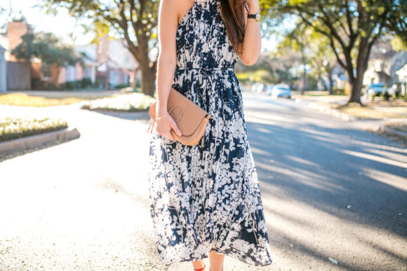 Amy Havins wears a printed midi dress and red heels. 
