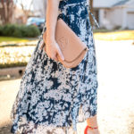 Amy Havins wears a printed midi dress and red heels.