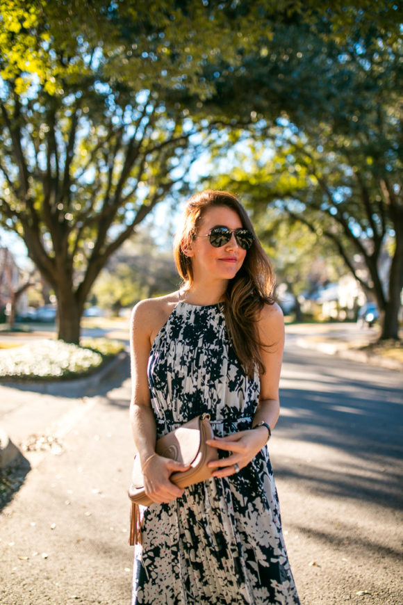 Amy Havins wears a printed midi dress and red heels. 