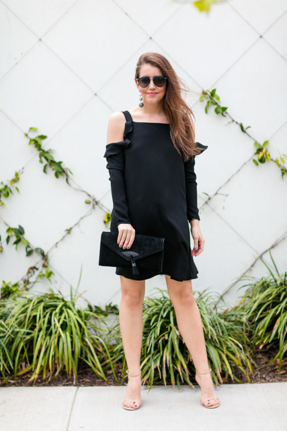 Amy Havins wears a black cold shoulder dress.