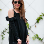 Amy Havins wears a black cold shoulder dress.