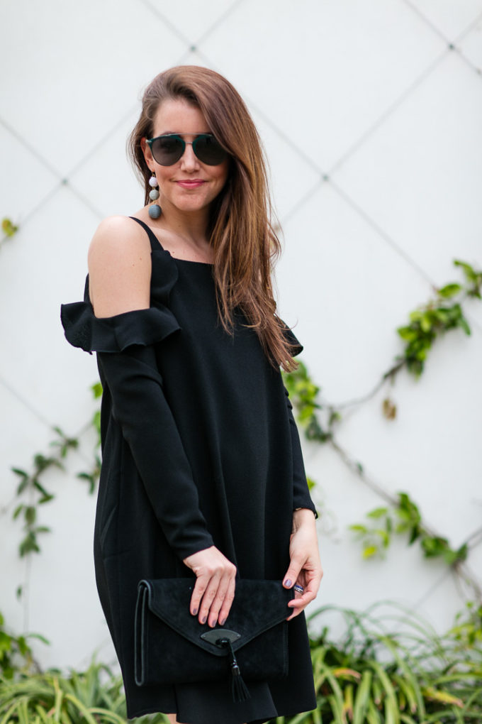 Amy Havins wears a black cold shoulder dress.