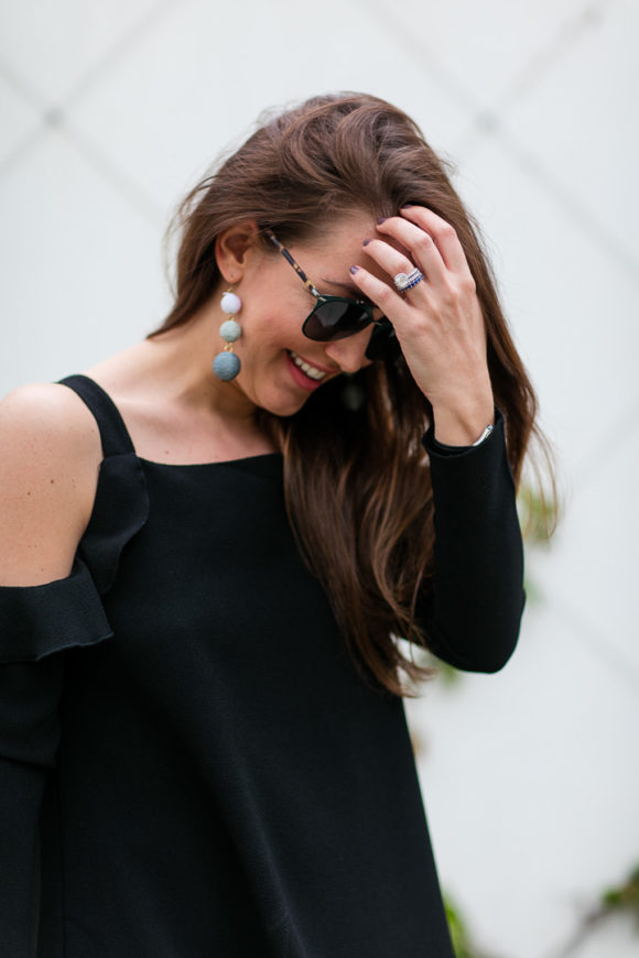 Amy Havins wears a black cold shoulder dress.