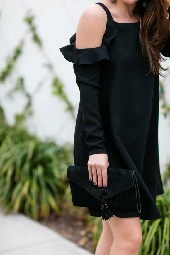 Amy Havins wears a black cold shoulder dress.