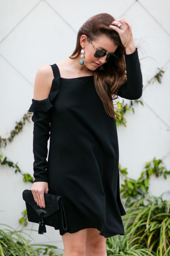 Amy Havins wears a black cold shoulder dress. 