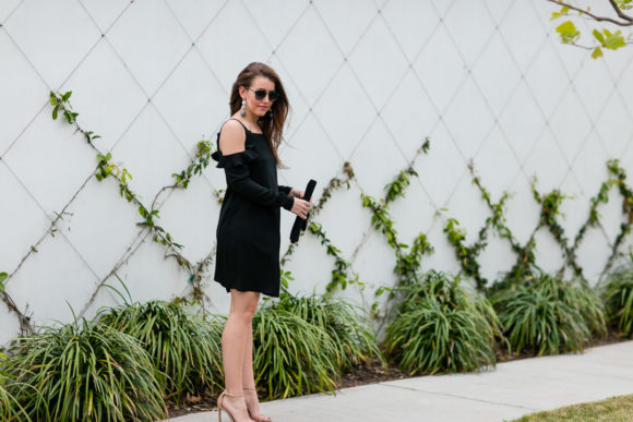 Amy Havins wears a black cold shoulder dress.