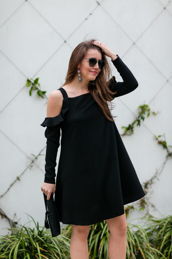 Amy Havins wears a black cold shoulder dress.