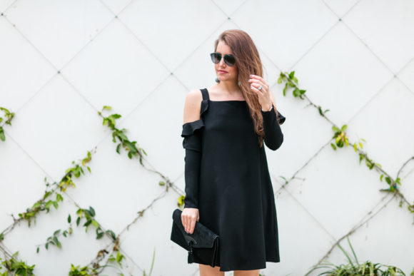 Amy Havins wears a black cold shoulder dress.