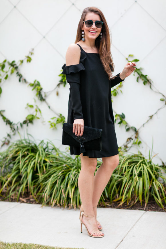 Amy Havins wears a black cold shoulder dress.