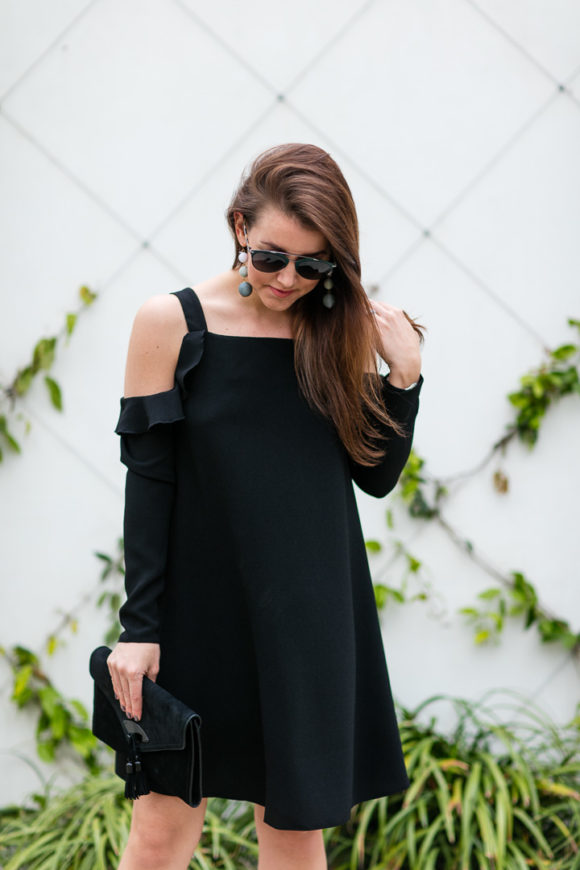 Amy Havins wears a black cold shoulder dress.