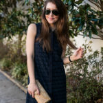 Amy havins wears a navy shift dress and spring sandals.