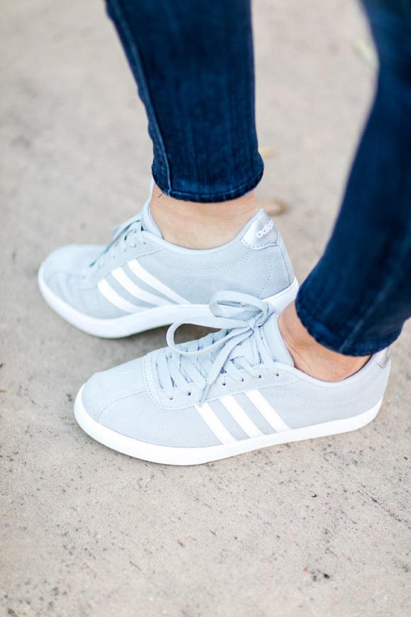 Amy Havins wears ripped jeans and a blue and white button down.