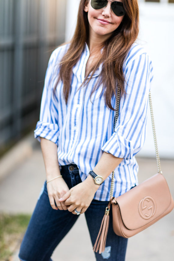 Amy Havins wears ripped jeans and a blue and white button down.