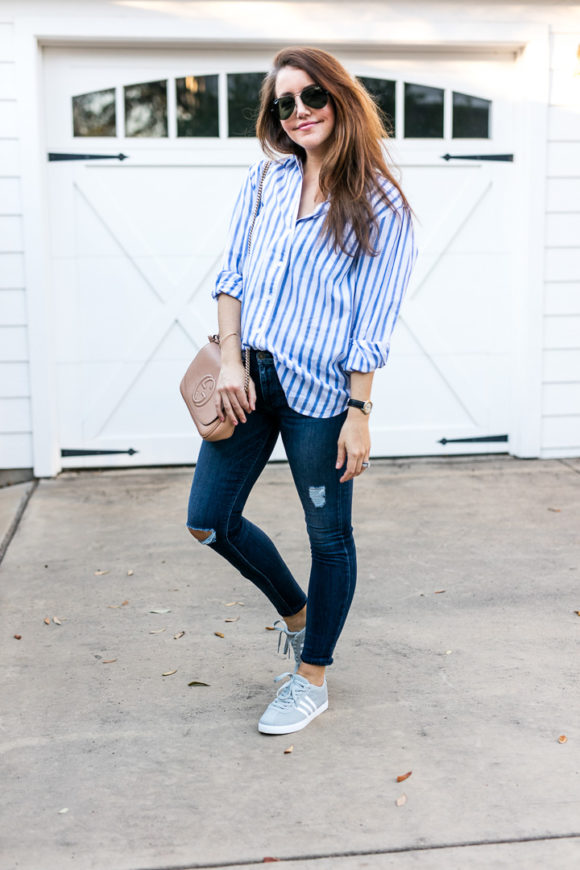 Amy Havins wears ripped jeans and a blue and white button down.