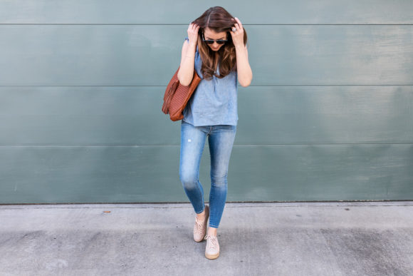 Amy Havins wears denim and a blouse from Stitch Fix.