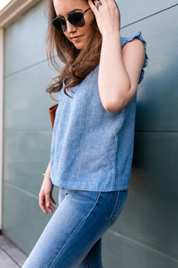 Amy Havins wears denim and a blouse from Stitch Fix.