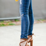 Amy havins wears ripped jeans and sandals.