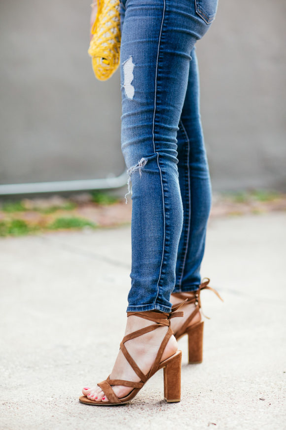 Amy havins wears ripped jeans and sandals. 