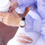 Amy havins wear a blue and white blouse with white jeans.