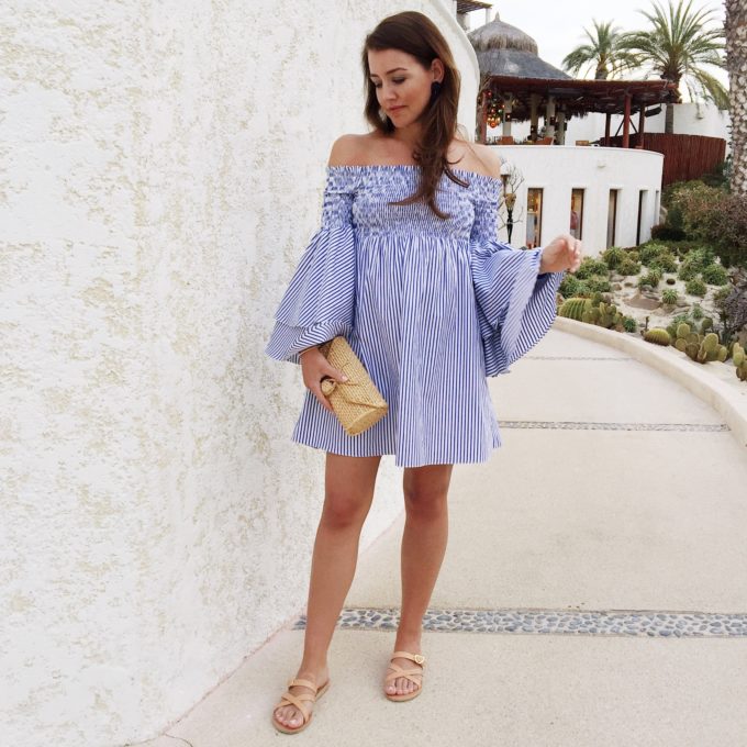 Amy Havins wears a blue and white striped off the shoulder dress.