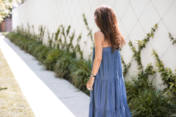 Amy Havins wears a denim tiered maxi dress with flats.