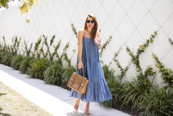 Amy Havins wears a denim tiered maxi dress with flats.