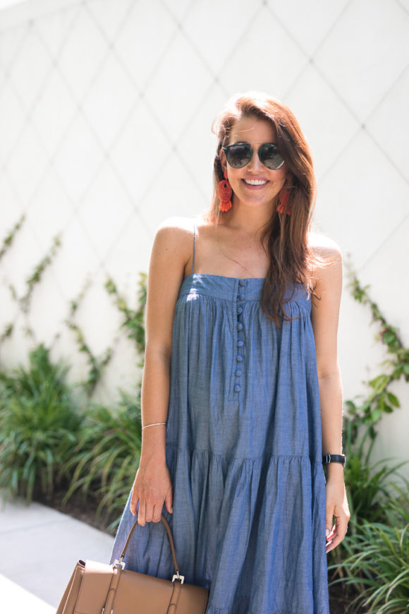 Amy Havins wears a denim tiered maxi dress with flats.