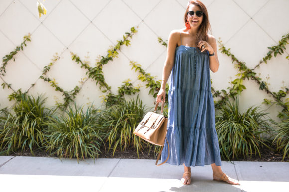 Amy Havins wears a denim tiered maxi dress with flats.