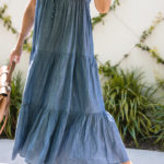 Amy Havins wears a denim tiered maxi dress with flats.