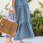 Amy Havins wears a denim tiered maxi dress with flats.