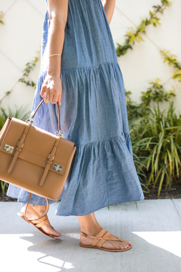 Amy Havins wears a denim tiered maxi dress with flats.