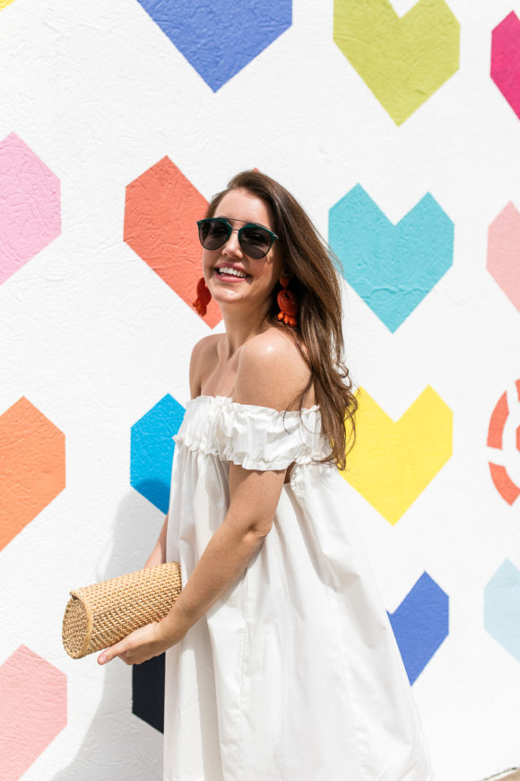 Amy Havins wears a white off the shoulder dress.