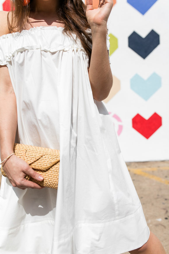 Amy Havins wears a white off the shoulder dress.